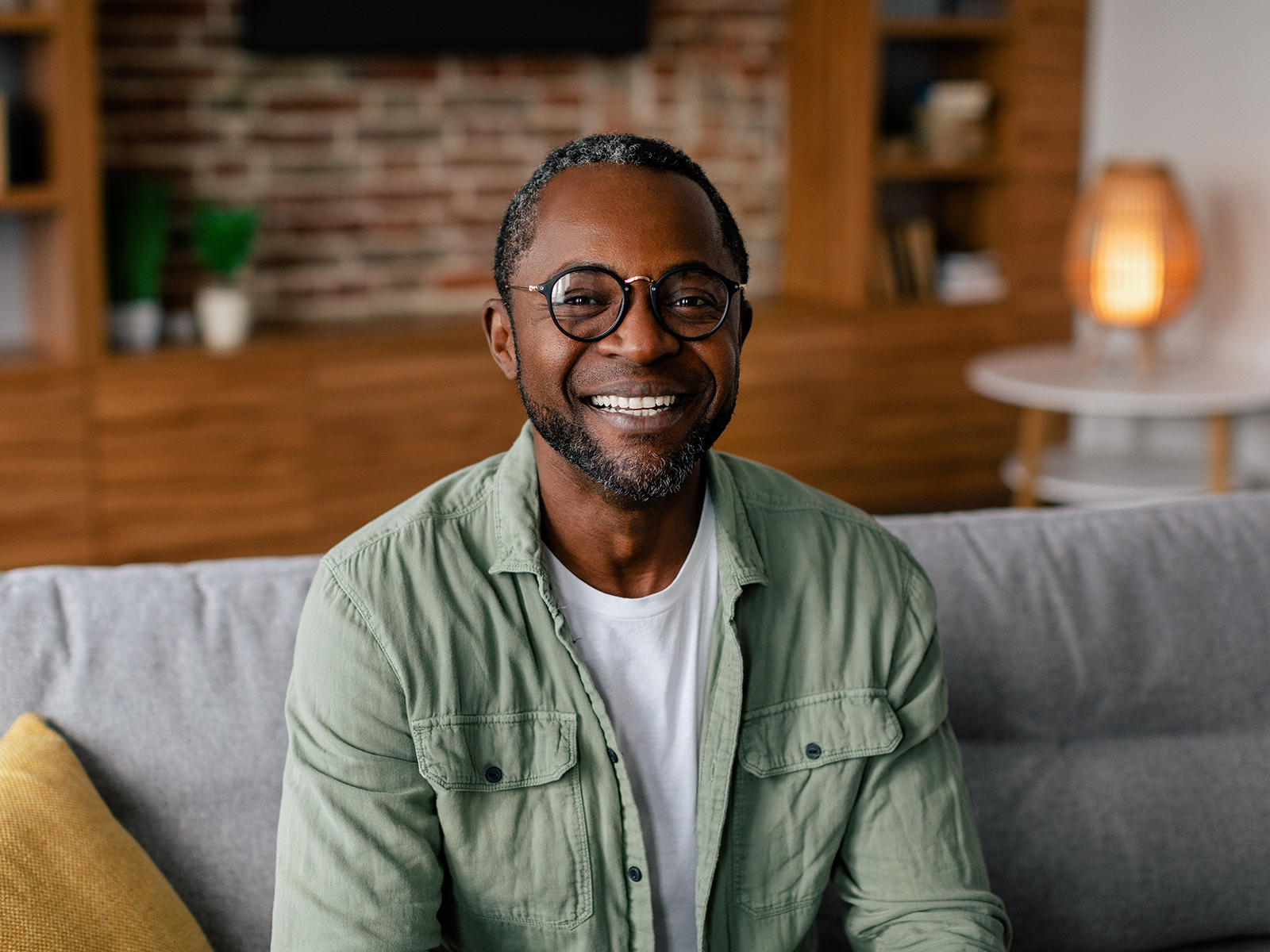 Man with glasses on couch