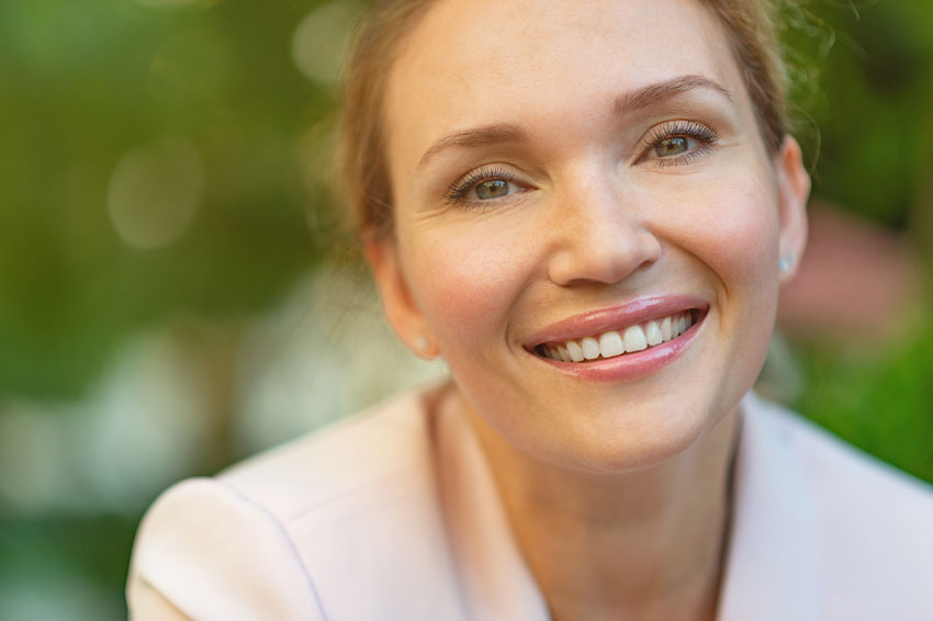 mature adult woman smiling with teeth