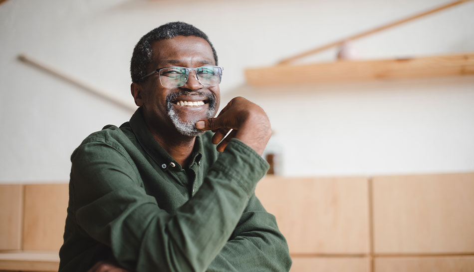 happy mature man with large glasses shows off his amazing smile